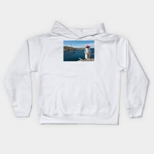 a sailboat passes the lighthouse Kids Hoodie